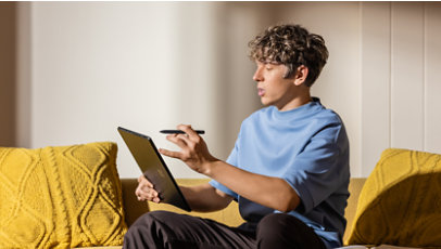 A student does his homework with a black Surface Pro, and Surface Slim Pen.